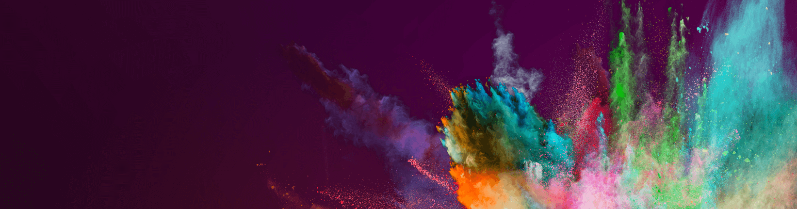 Colored powder explosion on dark gradient background.